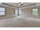 Large main bedroom with carpet, ceiling fan and tray ceiling at 4395 Wildbrooke Pkwy, Cumming, GA 30041