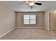 Spacious bedroom featuring carpet floors, a ceiling fan, and a window with blinds at 4395 Wildbrooke Pkwy, Cumming, GA 30041