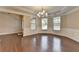 Open-concept dining room with hardwood floors, wainscoting, and a stylish chandelier at 4395 Wildbrooke Pkwy, Cumming, GA 30041