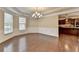 Bright dining room with detailed trim, bay window, hardwood floors, and an elegant chandelier at 4395 Wildbrooke Pkwy, Cumming, GA 30041