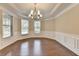 Elegant dining room featuring crown molding, hardwood floors, and a sophisticated chandelier at 4395 Wildbrooke Pkwy, Cumming, GA 30041