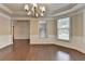 Spacious dining area boasting wood floors, wainscoting, a modern chandelier, and large windows at 4395 Wildbrooke Pkwy, Cumming, GA 30041