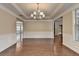 Expansive dining room showcasing hardwood floors, wainscoting detail, and a view into adjacent living spaces at 4395 Wildbrooke Pkwy, Cumming, GA 30041