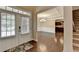 Welcoming entryway with gleaming hardwood floors leading to a dining area, kitchen, and staircase at 4395 Wildbrooke Pkwy, Cumming, GA 30041