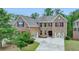 Lovely two-story brick home with well-manicured lawn and a spacious three-car garage and inviting burgundy shutters at 4395 Wildbrooke Pkwy, Cumming, GA 30041