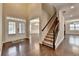 Grand foyer with hardwood floors, staircase, and elegant entryway doors at 4395 Wildbrooke Pkwy, Cumming, GA 30041