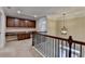 Upstairs hallway with built-in cabinets and a modern light fixture at 4395 Wildbrooke Pkwy, Cumming, GA 30041