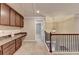 Hallway features cabinets, a countertop, view of stairway with railing and view to another room at 4395 Wildbrooke Pkwy, Cumming, GA 30041