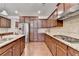 Kitchen with gas stove, stainless appliances, granite counters, and wood cabinets at 4395 Wildbrooke Pkwy, Cumming, GA 30041