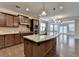 Open kitchen boasts a large island, stainless steel appliances, granite countertops, and a view of the breakfast area at 4395 Wildbrooke Pkwy, Cumming, GA 30041