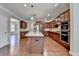 Open kitchen with stainless appliances and granite countertops open to the dining area at 4395 Wildbrooke Pkwy, Cumming, GA 30041
