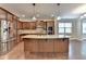 Well-lit kitchen with a granite island, stainless steel appliances, and hardwood floors at 4395 Wildbrooke Pkwy, Cumming, GA 30041