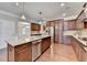 Kitchen with stainless steel appliances, granite countertops, and a wooden island at 4395 Wildbrooke Pkwy, Cumming, GA 30041
