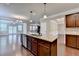 Open-concept kitchen with granite countertops, stainless steel dishwasher, and island seating at 4395 Wildbrooke Pkwy, Cumming, GA 30041
