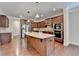 Open kitchen with an island featuring a granite countertop, stainless steel appliances, and wood cabinets at 4395 Wildbrooke Pkwy, Cumming, GA 30041