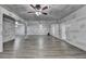 Unfinished living room with laminate floors and ceiling fans with protective wall coverings at 4395 Wildbrooke Pkwy, Cumming, GA 30041
