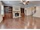 Living room featuring a stone fireplace and built-in bookshelves at 4395 Wildbrooke Pkwy, Cumming, GA 30041