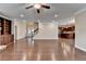 Open-concept living room with hardwood floors, a staircase, and access to the kitchen at 4395 Wildbrooke Pkwy, Cumming, GA 30041