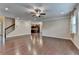 Spacious living room featuring hardwood floors, a ceiling fan, and easy access to the kitchen at 4395 Wildbrooke Pkwy, Cumming, GA 30041