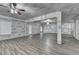 Unfinished living room with laminate floors and ceiling fans with protective wall coverings at 4395 Wildbrooke Pkwy, Cumming, GA 30041