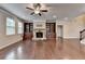 Spacious living room featuring a stone fireplace and built-in bookshelves at 4395 Wildbrooke Pkwy, Cumming, GA 30041