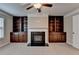 The living room features a fireplace, built in cabinets, neutral colors and carpet at 4395 Wildbrooke Pkwy, Cumming, GA 30041
