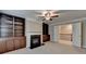 Open-concept living room with fireplace, built-in cabinets, neutral walls and adjacent stairway at 4395 Wildbrooke Pkwy, Cumming, GA 30041
