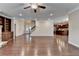 Open-concept living room with hardwood floors, a staircase, and access to the kitchen at 4395 Wildbrooke Pkwy, Cumming, GA 30041