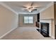 Living room with fireplace, built-in shelving, and abundant natural light at 4395 Wildbrooke Pkwy, Cumming, GA 30041
