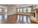 Bright living room with hardwood floors, a stone fireplace, and large windows at 4395 Wildbrooke Pkwy, Cumming, GA 30041