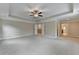 Spacious main bedroom features a trey ceiling, neutral walls and carpet, and multiple entryways at 4395 Wildbrooke Pkwy, Cumming, GA 30041