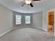 Bright main bedroom with neutral colors, ceiling fan, and lots of natural light at 4395 Wildbrooke Pkwy, Cumming, GA 30041