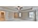 Main bedroom has large floor plan, tray ceiling and carpeted floor at 4395 Wildbrooke Pkwy, Cumming, GA 30041