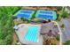 Aerial shot showcases the pool and tennis courts with lush landscaping in a well-kept community at 4395 Wildbrooke Pkwy, Cumming, GA 30041