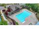 Aerial shot showcases the pool with clubhouse and lush landscaping in a well-kept community at 4395 Wildbrooke Pkwy, Cumming, GA 30041
