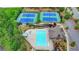Aerial shot showcases the pool and tennis courts with lush landscaping in a well-kept community at 4395 Wildbrooke Pkwy, Cumming, GA 30041