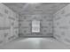 Unfinished room with laminate floors and a window with protective covering on walls at 4395 Wildbrooke Pkwy, Cumming, GA 30041