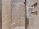 Tiled shower featuring a built-in seat, providing a spa-like experience in your own home at 4395 Wildbrooke Pkwy, Cumming, GA 30041