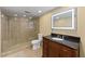 Bathroom featuring a stone shower, LED mirror, and dark wood vanity at 4631 Crooked Creek Ln, Villa Rica, GA 30180