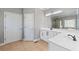 Bright bathroom with double sinks, white cabinets, tile flooring, and a glass-enclosed shower at 4631 Crooked Creek Ln, Villa Rica, GA 30180