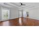 Spacious primary bedroom featuring hardwood floors, tray ceilings, and plenty of natural light at 4631 Crooked Creek Ln, Villa Rica, GA 30180