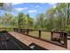 Wooden deck with black railings and a tranquil view of the surrounding woods at 4631 Crooked Creek Ln, Villa Rica, GA 30180