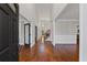 Welcoming foyer with hardwood floors, a staircase, and access to a living area with bright, neutral paint at 4631 Crooked Creek Ln, Villa Rica, GA 30180