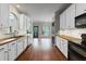 White kitchen with wood countertops, modern appliances, and view to the backyard at 4631 Crooked Creek Ln, Villa Rica, GA 30180