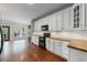 Stylish kitchen featuring white cabinets, wood countertops, and black appliances, creating a modern look at 4631 Crooked Creek Ln, Villa Rica, GA 30180