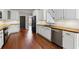 Well-lit kitchen with white cabinets, wood countertops, stainless steel appliances and a view to the staircase at 4631 Crooked Creek Ln, Villa Rica, GA 30180