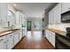 Bright kitchen with white cabinets, wood countertops, stainless steel appliances, and hardwood floors at 4631 Crooked Creek Ln, Villa Rica, GA 30180