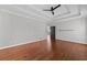 Open main bedroom featuring hardwood floors and tray ceilings with a ceiling fan at 4631 Crooked Creek Ln, Villa Rica, GA 30180