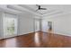 Spacious main bedroom featuring hardwood floors, tray ceilings, and windows offering ample natural light at 4631 Crooked Creek Ln, Villa Rica, GA 30180
