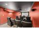 Home theater room with plush seating, a projection screen, and dim lighting at 4631 Crooked Creek Ln, Villa Rica, GA 30180